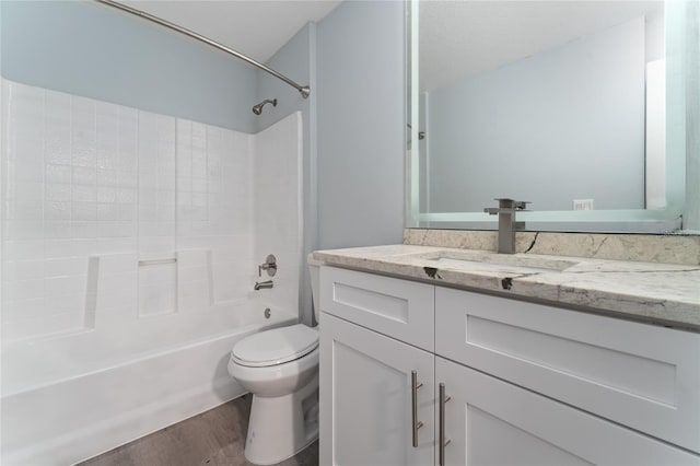 full bathroom featuring vanity, wood-type flooring, bathing tub / shower combination, and toilet