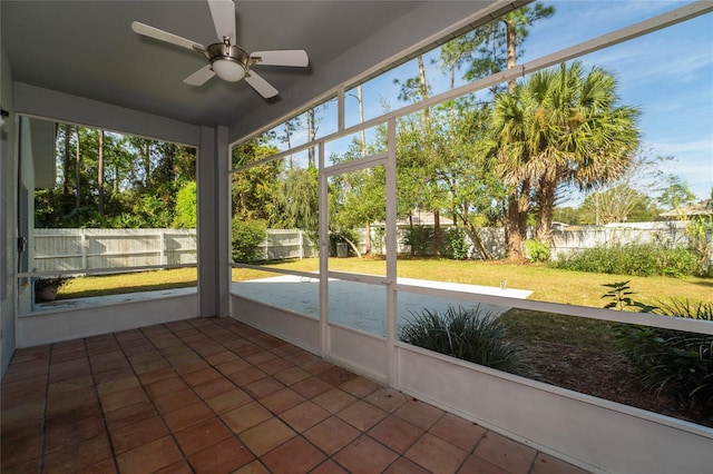 unfurnished sunroom featuring ceiling fan