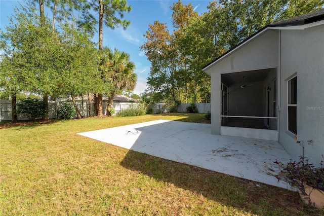 view of yard with a sunroom and a patio area