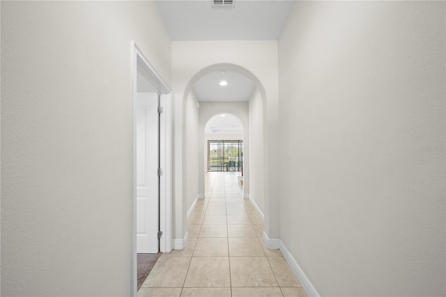 corridor with light tile patterned floors