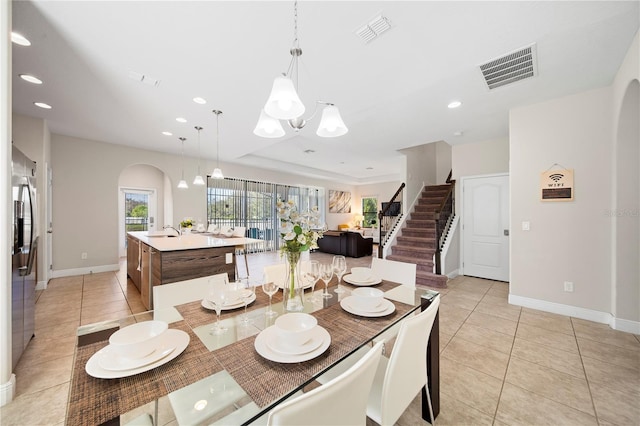 tiled dining space featuring sink