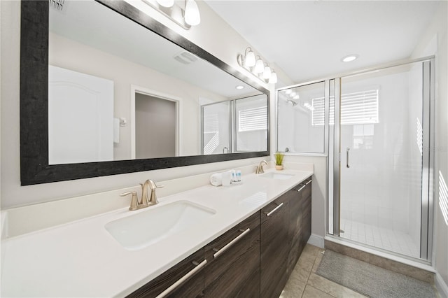 bathroom with vanity, a shower with shower door, and tile patterned flooring