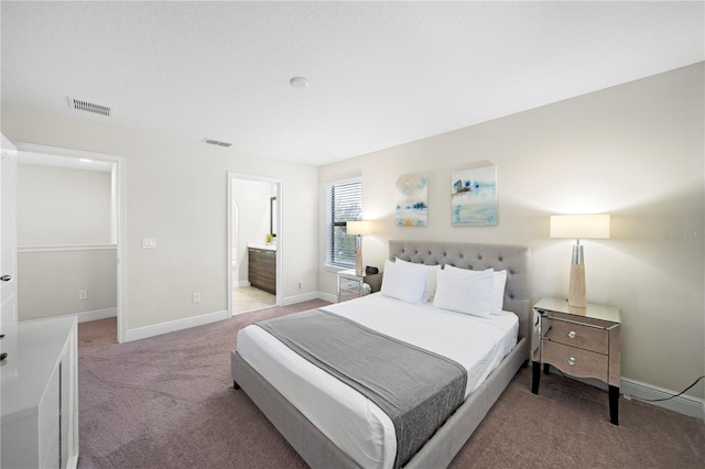 carpeted bedroom featuring ensuite bathroom