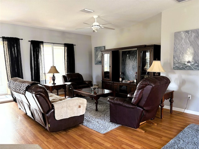 living room featuring ceiling fan and light hardwood / wood-style floors