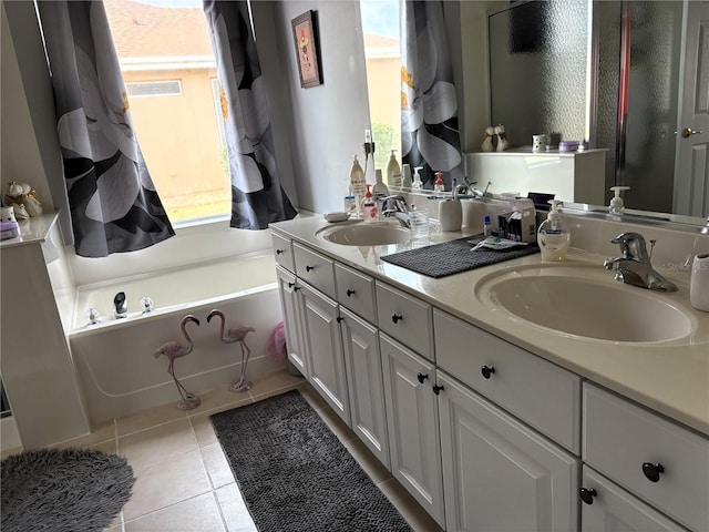 bathroom featuring a washtub, vanity, and tile patterned floors