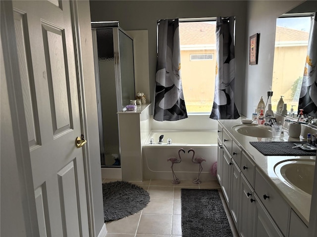 bathroom with double vanity, tile patterned flooring, plenty of natural light, and a sink