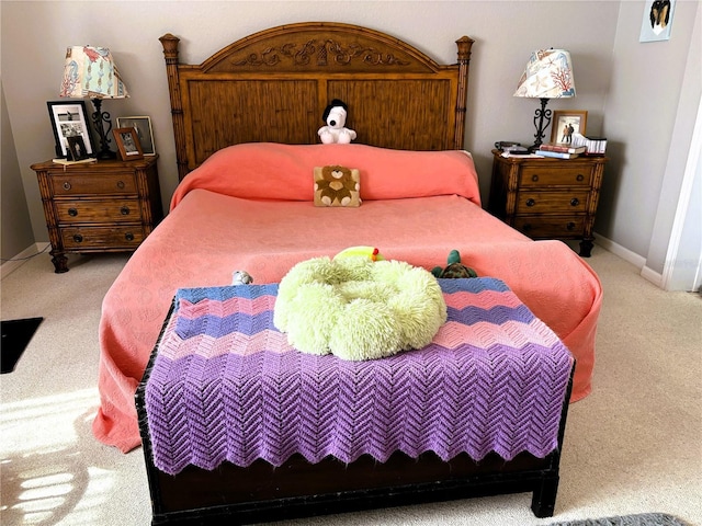 bedroom with baseboards and light colored carpet