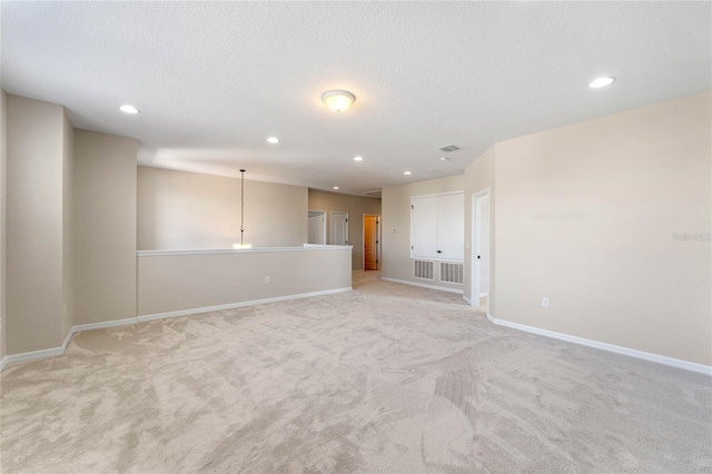 spare room featuring recessed lighting and a textured ceiling