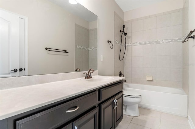 full bath featuring tile patterned floors, washtub / shower combination, toilet, and vanity