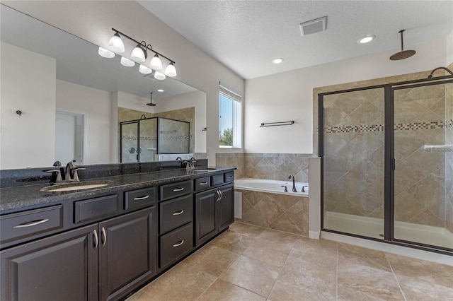 bathroom featuring a sink, visible vents, a garden tub, and a stall shower