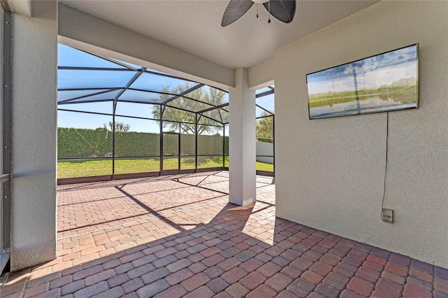 view of patio / terrace featuring a lanai and ceiling fan