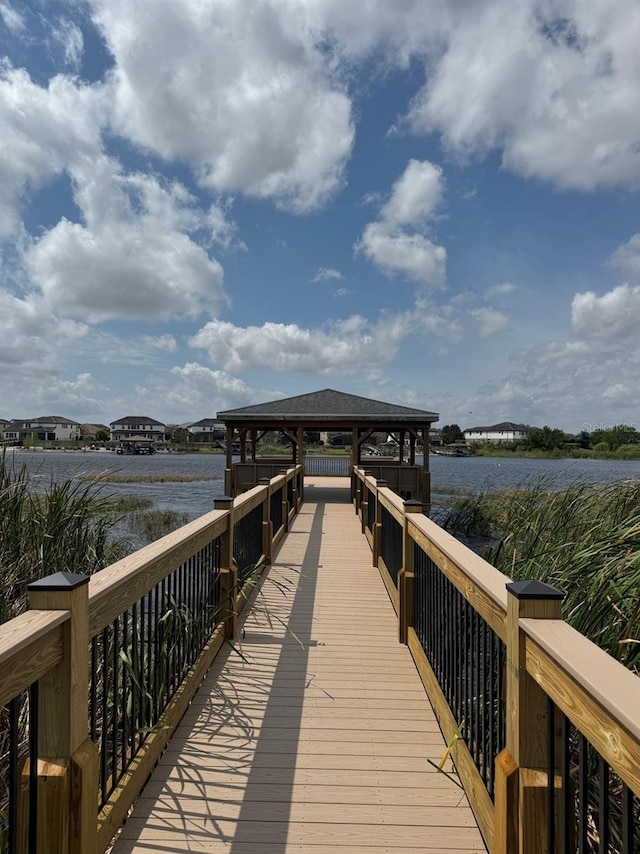 view of dock featuring a gazebo and a water view