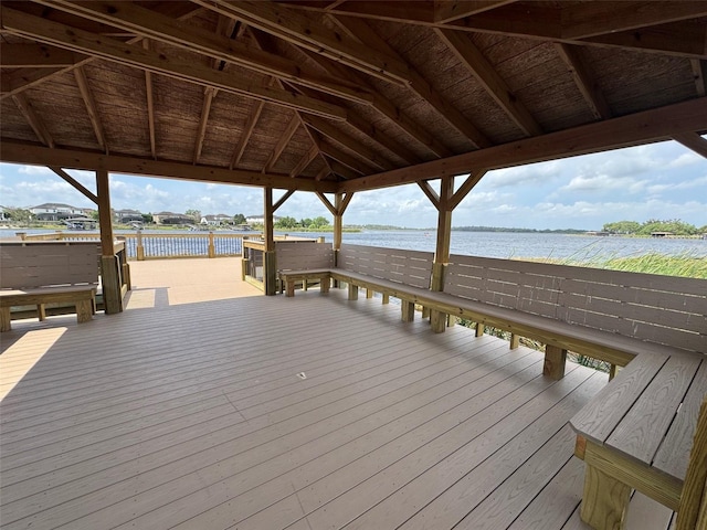 view of dock with a gazebo and a deck with water view