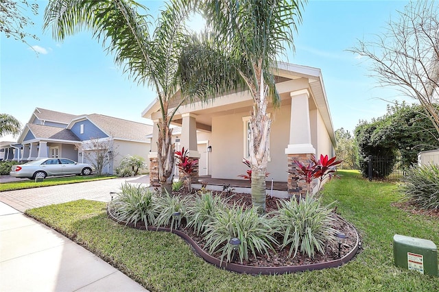 view of front of property with a porch and a front lawn