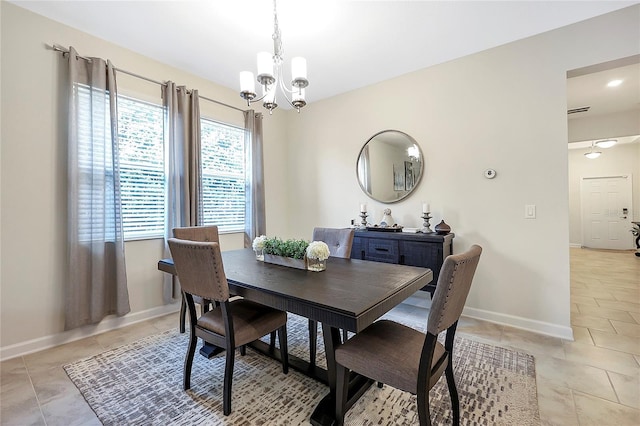 dining space with light tile patterned floors and a notable chandelier