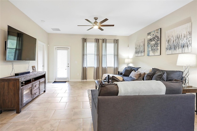 tiled living room featuring ceiling fan