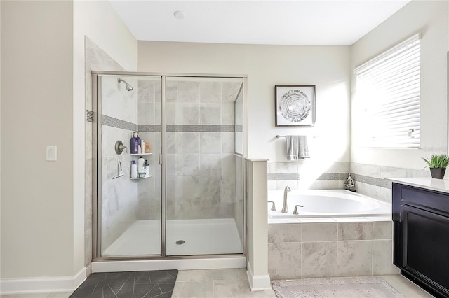 bathroom with vanity and shower with separate bathtub