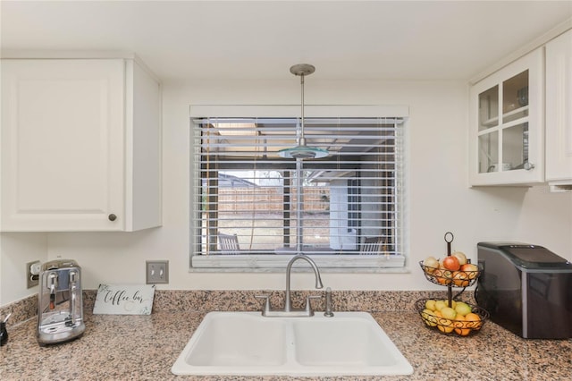 kitchen with white cabinetry and sink