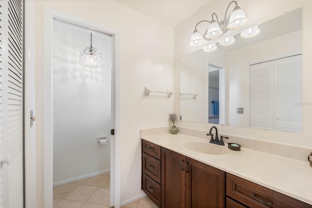 bathroom with vanity, tile patterned floors, and a chandelier