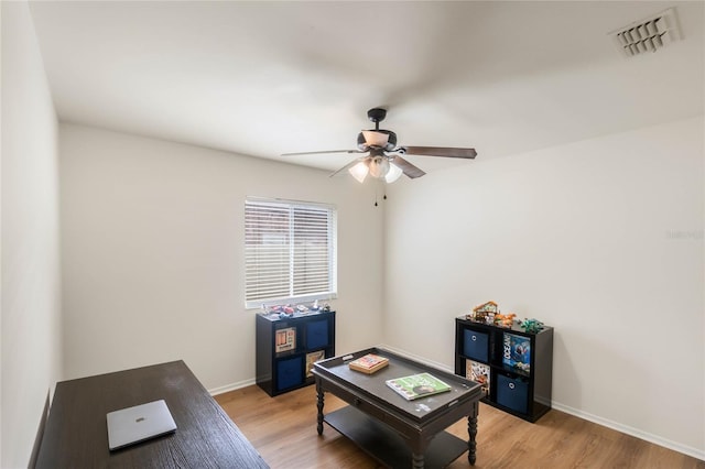 office space with ceiling fan and light hardwood / wood-style floors