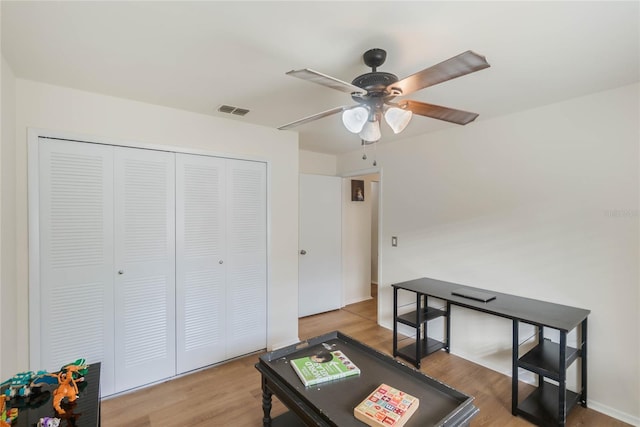 game room with ceiling fan and light hardwood / wood-style flooring