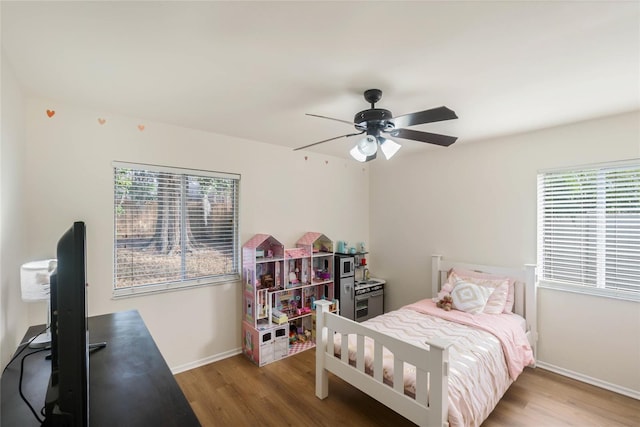 bedroom with hardwood / wood-style floors and ceiling fan