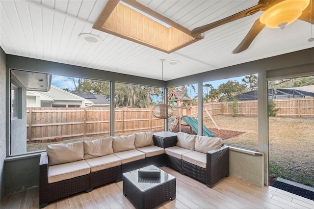 sunroom featuring wood ceiling and plenty of natural light