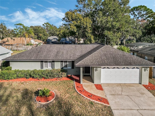 ranch-style home featuring a garage and a front yard