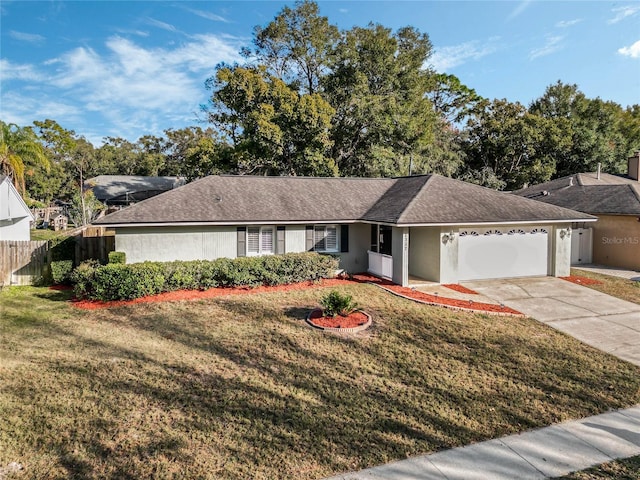 ranch-style home with a garage and a front lawn