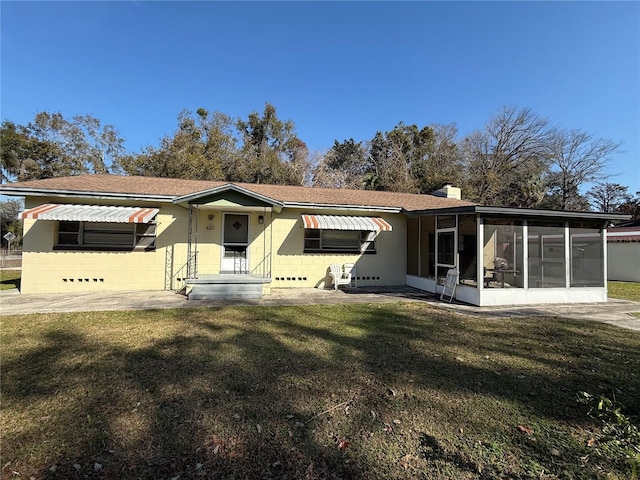 view of front of property with a sunroom and a front yard