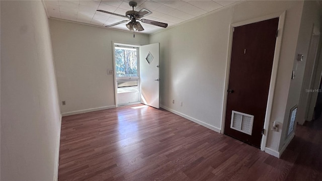 empty room with crown molding, wood-type flooring, and ceiling fan