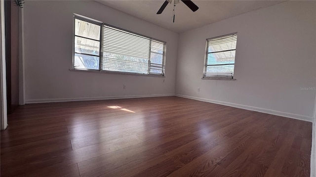 empty room with dark hardwood / wood-style floors and ceiling fan