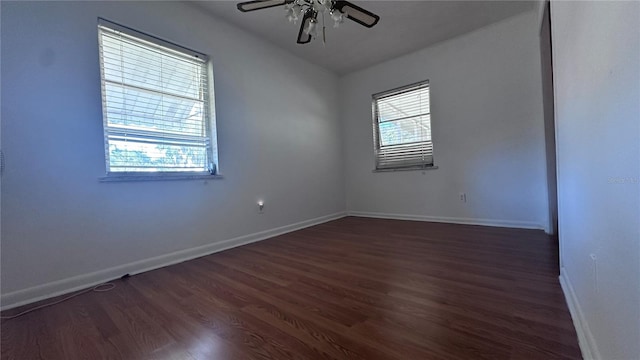 spare room featuring ceiling fan and dark hardwood / wood-style flooring