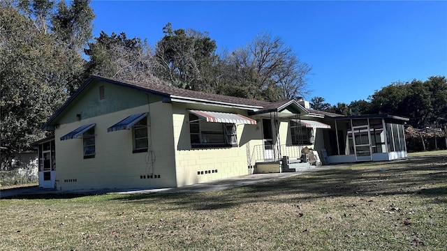 view of front of house with a sunroom and a front yard