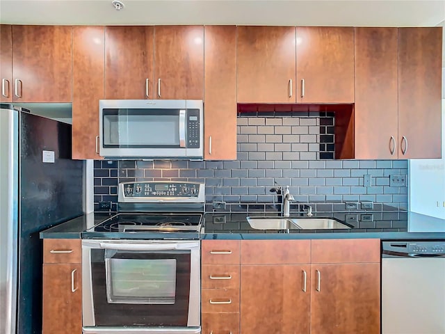 kitchen featuring appliances with stainless steel finishes, sink, and backsplash