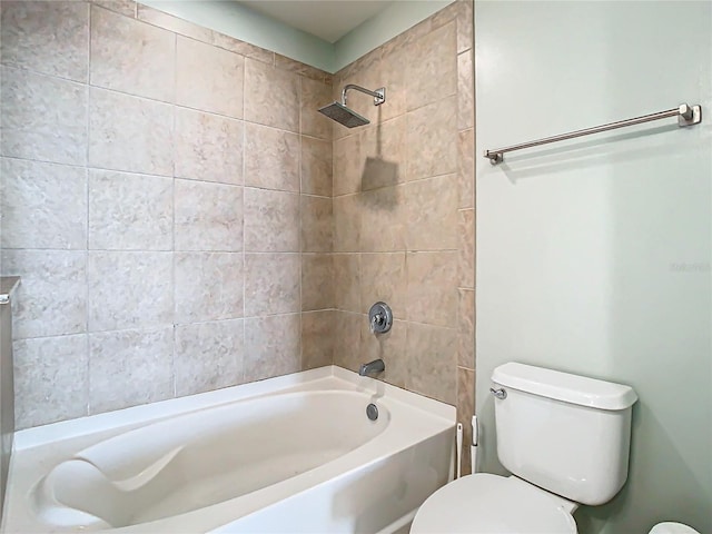 bathroom featuring toilet and tiled shower / bath