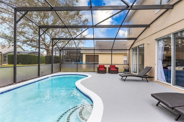 view of swimming pool with a patio and a lanai