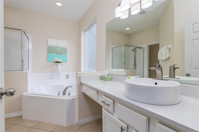 bathroom with tile patterned floors, vanity, and separate shower and tub