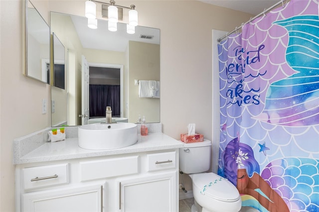 bathroom featuring walk in shower, vanity, and toilet