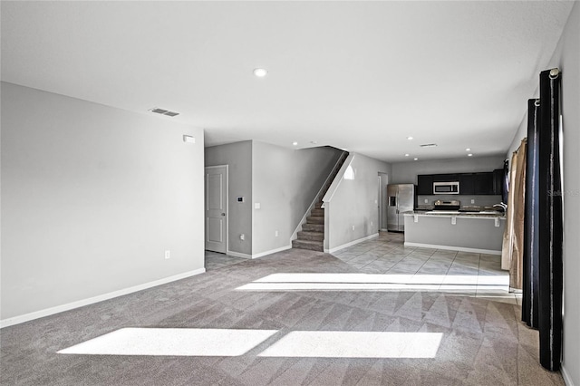 unfurnished living room with light carpet