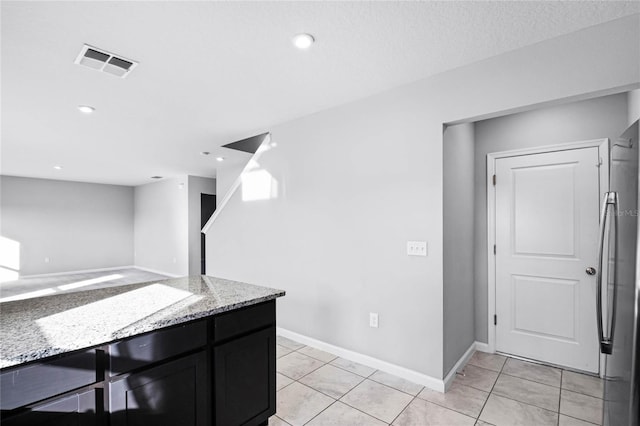 kitchen featuring light stone countertops and light tile patterned floors