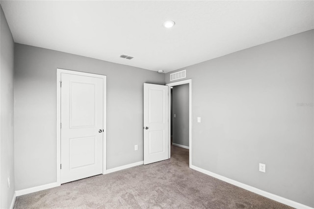 unfurnished bedroom featuring light carpet