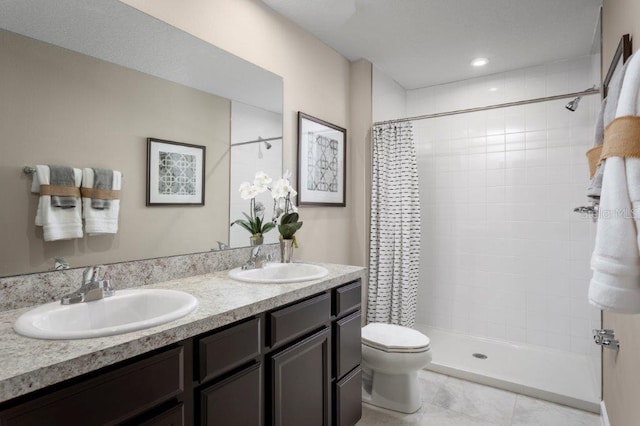 bathroom with vanity, tile patterned flooring, curtained shower, and toilet