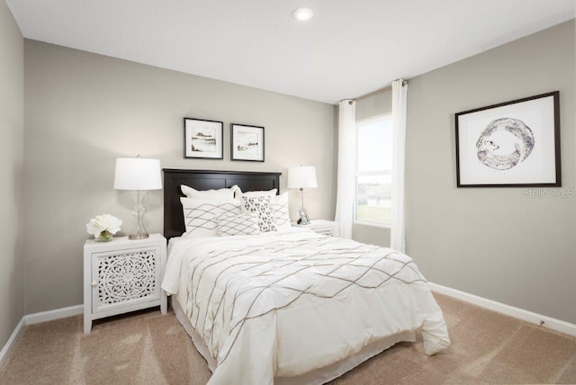 bedroom with light colored carpet