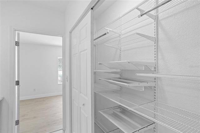 walk in closet featuring light hardwood / wood-style flooring