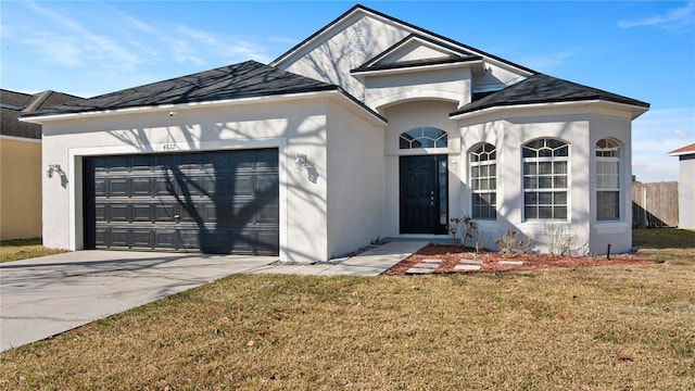 view of front of home with a garage and a front lawn