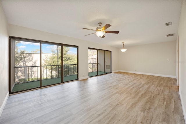 spare room featuring ceiling fan and light wood-type flooring