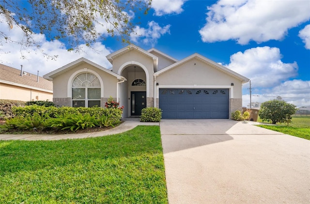 view of front of house with a garage and a front lawn