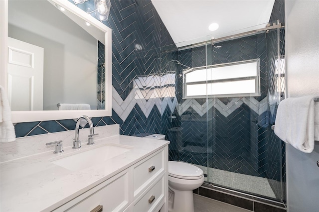 bathroom featuring vanity, walk in shower, and toilet