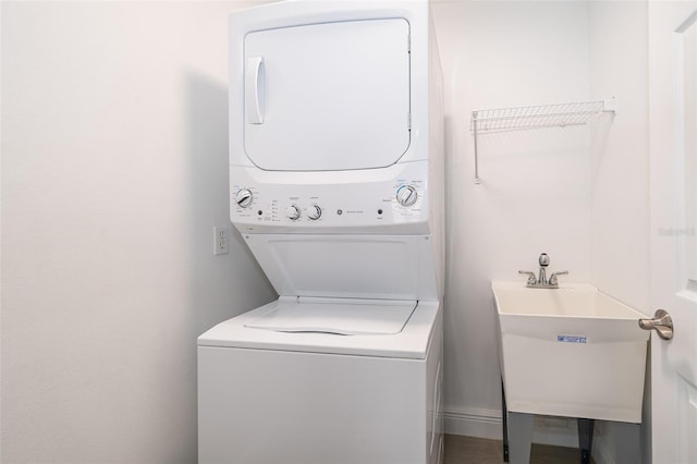 laundry room featuring stacked washer and dryer and sink